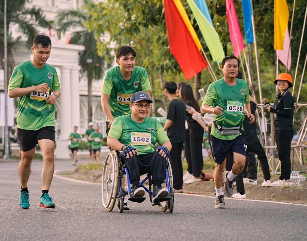 A group of men participating in a marathon in Can Tho, Vietnam, some in wheelchairs.