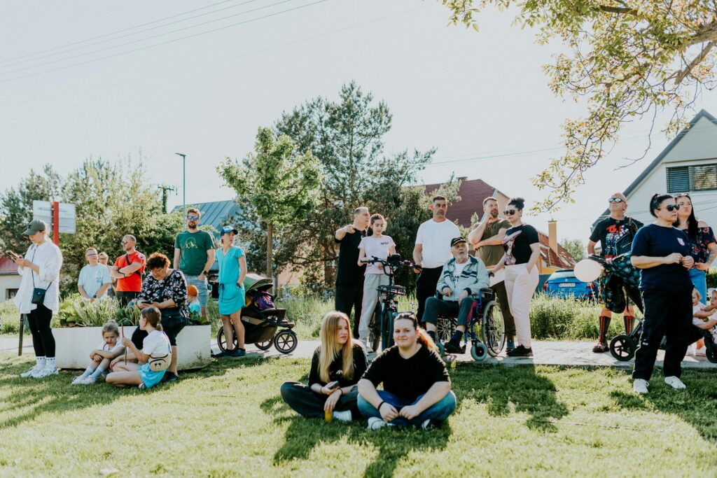 A diverse group enjoying a sunny day outdoors, showcasing community and togetherness.