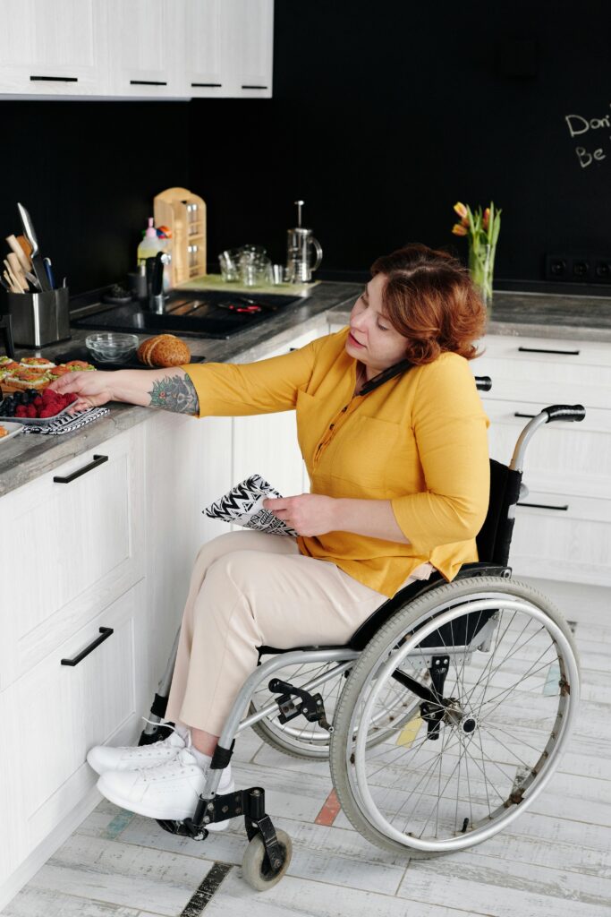 Woman in a wheelchair engaging in daily activities at home, promoting inclusivity.