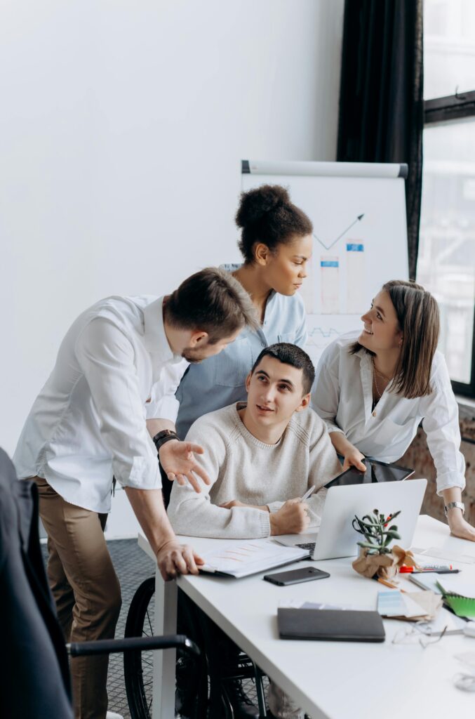 A diverse team of young professionals collaborating in a modern office setting.
