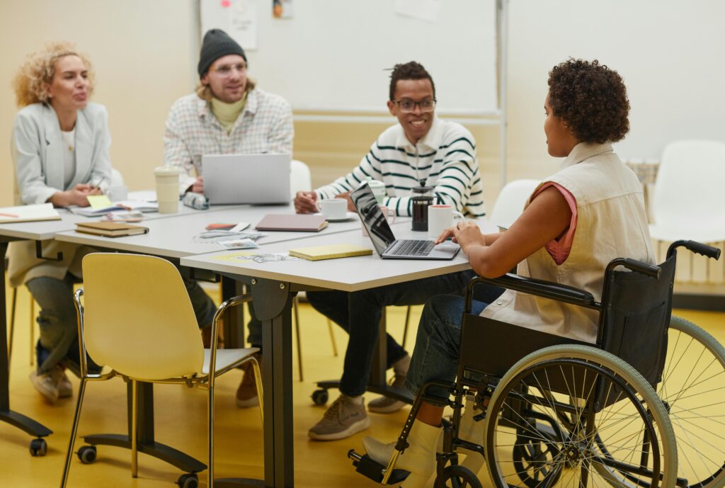 Group of diverse coworkers brainstorming and collaborating in a modern office setting.