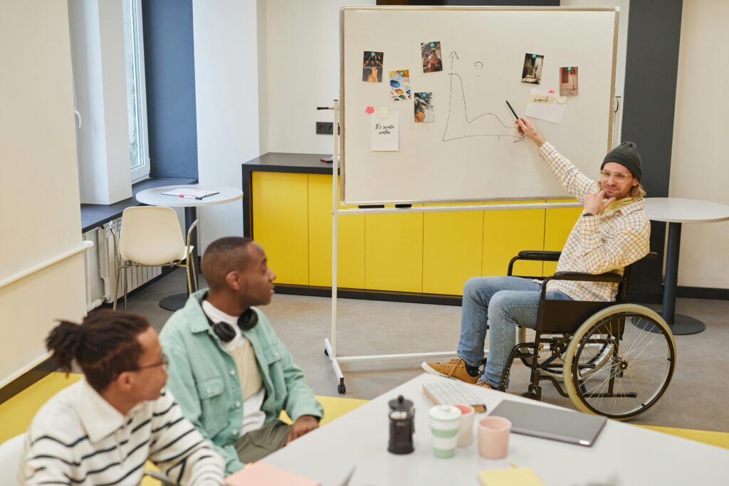 Diverse team discussing ideas during a meeting with a whiteboard presentation.