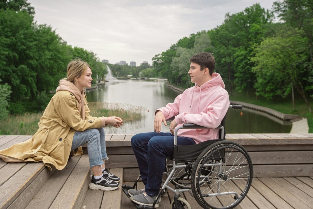 A couple enjoys time together by the river, highlighting love and support.