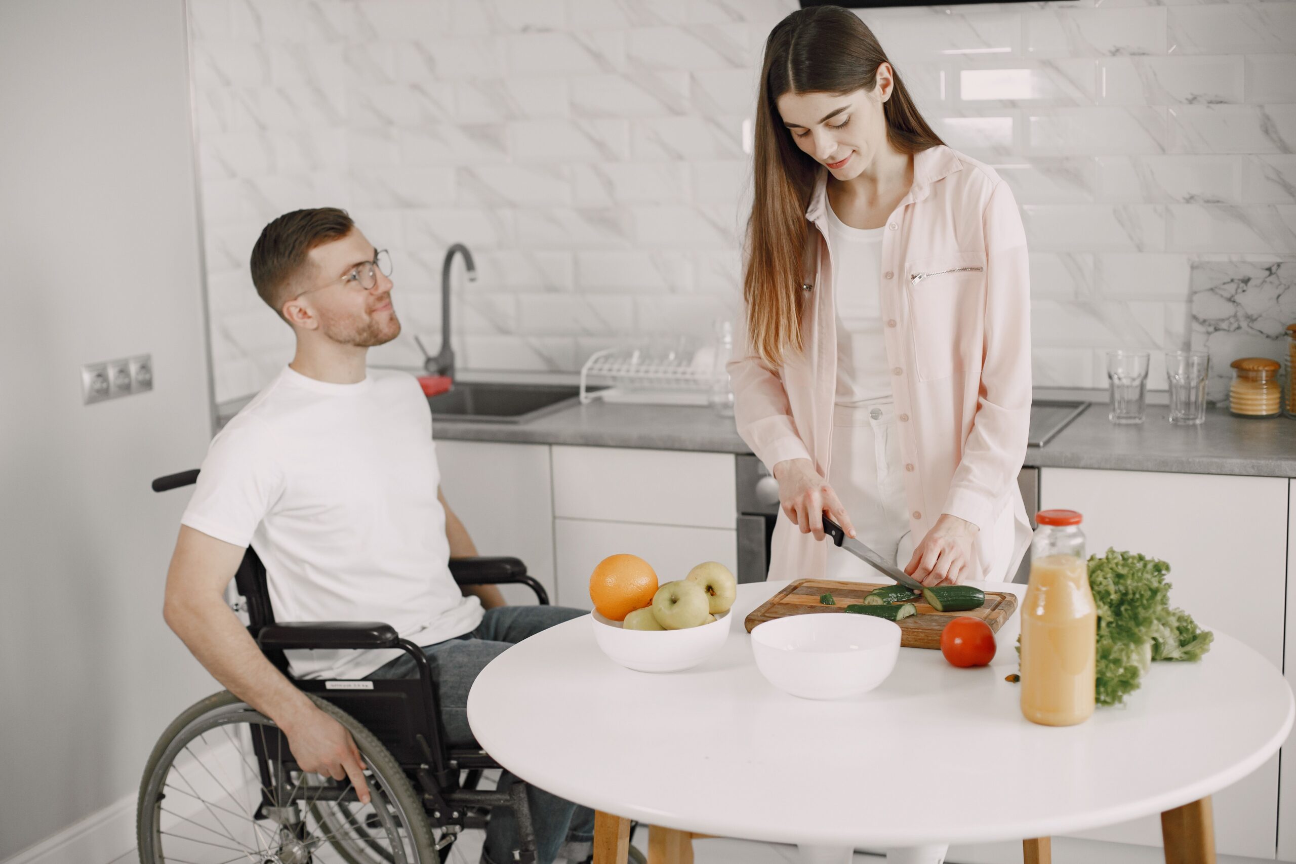 A couple cooking together in a modern kitchen, fostering teamwork and joy.